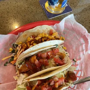 Two grilled chicken tacos and one street corn shrimp taco, Baja style.