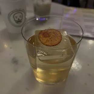 a drink and a cookie on a table