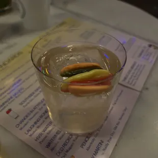 a glass of water with a slice of fruit in it