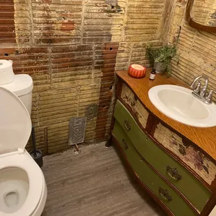 a bathroom with a brick wall