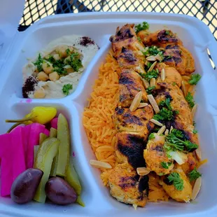 Tawook (chicken kabobs) over Basmati rice with hummus and pickels.