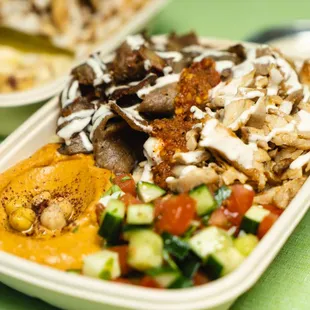 Bowl - Hummus Base, Half chicken shawarma half gyro, spicy hummus side and Mediterranean salad side.