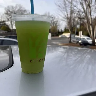 a green drink in a plastic cup