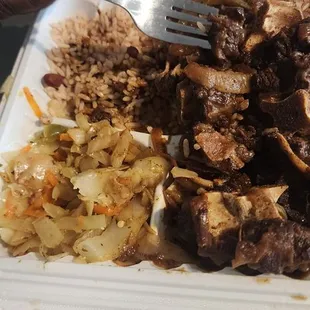Oxtails, rice and peas, cabbage