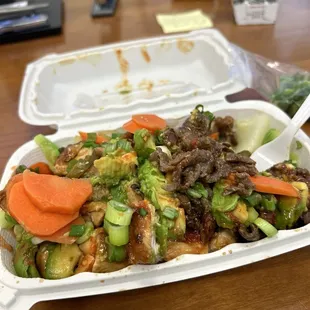 Chicken and steak with veggies, green onions and pickled carrots &amp; jalapeños.