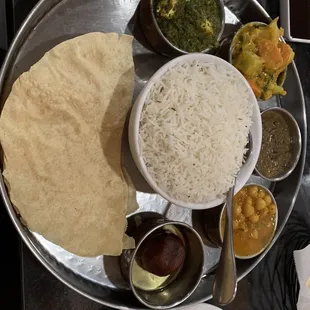 Nepali Thali ( Dal Bhat ) 4 variety of veggies. Everything was delicious. It even came with a dessert. Came with a lot of rice too.