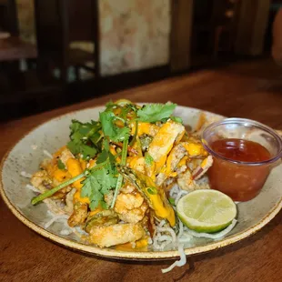 Calamari Appetizer - mixture of squid, sweet potato, onions, and jalapeños with side of sweet chili sauce and lime.