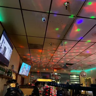 a restaurant with disco lights on the ceiling