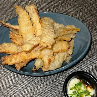 a plate of food with dipping sauce