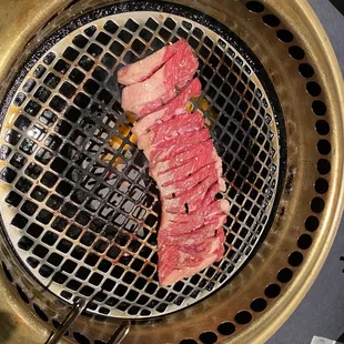 a steak being cooked on a grill