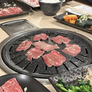 a variety of meats being prepared