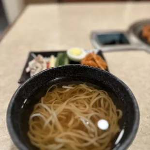 a bowl of noodles and vegetables