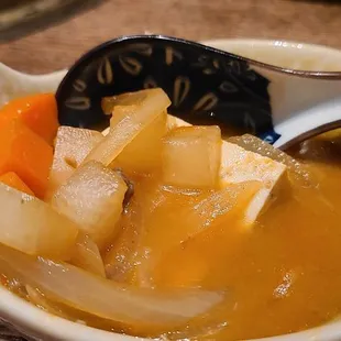 a bowl of soup with a spoon