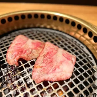 two pieces of meat on a grill