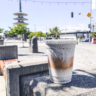 a cup of coffee on a bench
