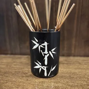 bamboo sticks in a black cup