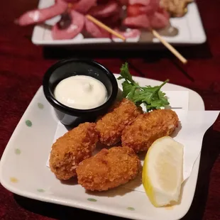 Deep fried oyster (front) and sausage (back).