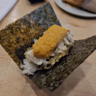 Uni with blue crab and fried perilla leaf nigiri