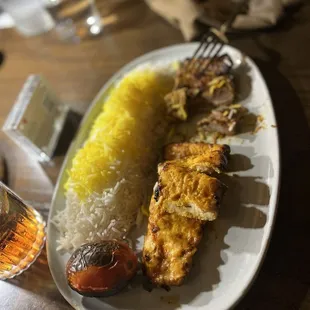 Chicken barg and beef barg pieces with saffron rice and roasted tomato