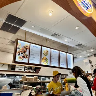 a man and a woman ordering food at a restaurant