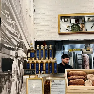 a man behind a counter in a bakery