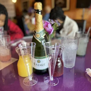 a bottle of champagne and glasses