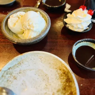 Vanilla ice cream, chocolate syrup, whip cream and maraschino cherries to share