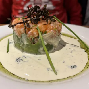 a plate of sushi with sauce on it