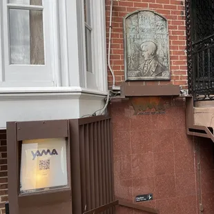 a brick building with a sign on it