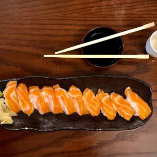 10 salmon nigiris and some sake.