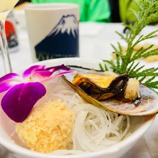 a bowl of food and a glass of wine