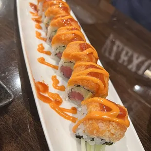 a plate of sushi with sauce on it