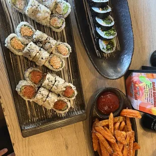 Cali roll, shrimp tempura, spicy tuna, veggie roll, and sweet potato fries