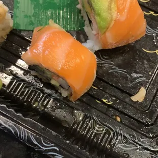 sushi rolls on a plastic tray