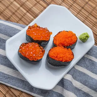 three pieces of sushi on a plate