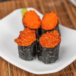 three pieces of sushi on a plate