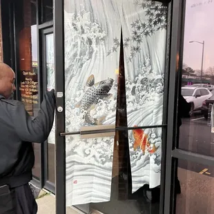 a man standing in front of a window