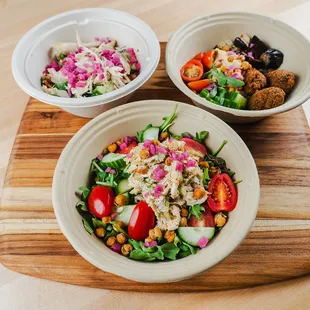 three bowls of salad