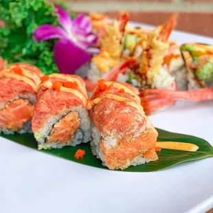 a plate of sushi with a flower