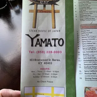 a hand holding a menu for a restaurant