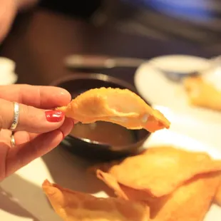 a person holding a piece of food