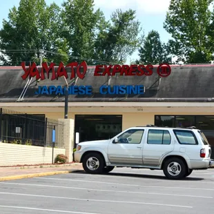 a car parked in front of a restaurant