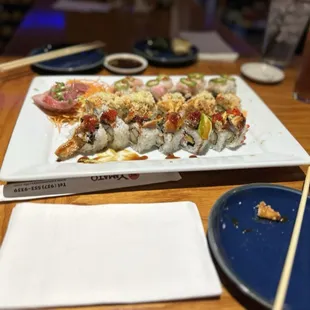 a plate of sushi and chopsticks