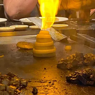 a person cooking food on a grill