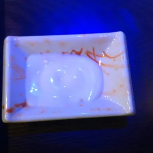 Yami Yami sauce in a squirt bottle on each table.