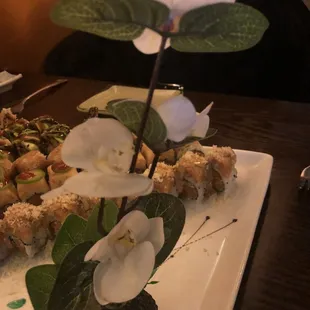 Sushi tray had a cute plastic orchid