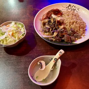 Filet mignon, lobster tail, soup, fried rice, veggies, and salad.