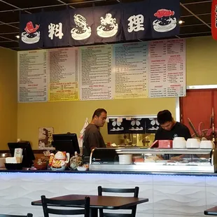 two men working behind the counter