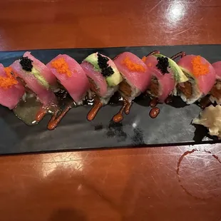 a sushi roll on a black plate