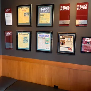 a booth with seating and posters on the wall